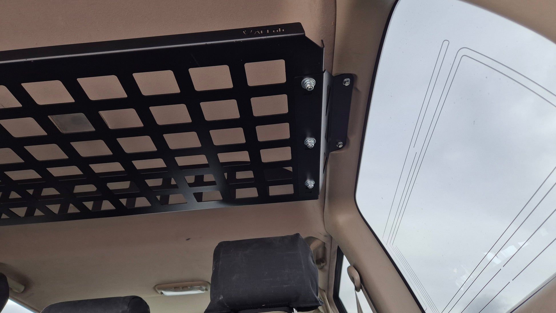 Black metal grid attached to a vehicle's interior ceiling